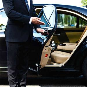 Chauffeur invitant le voyageur a entré dans le véhicule Transport Bretagne.